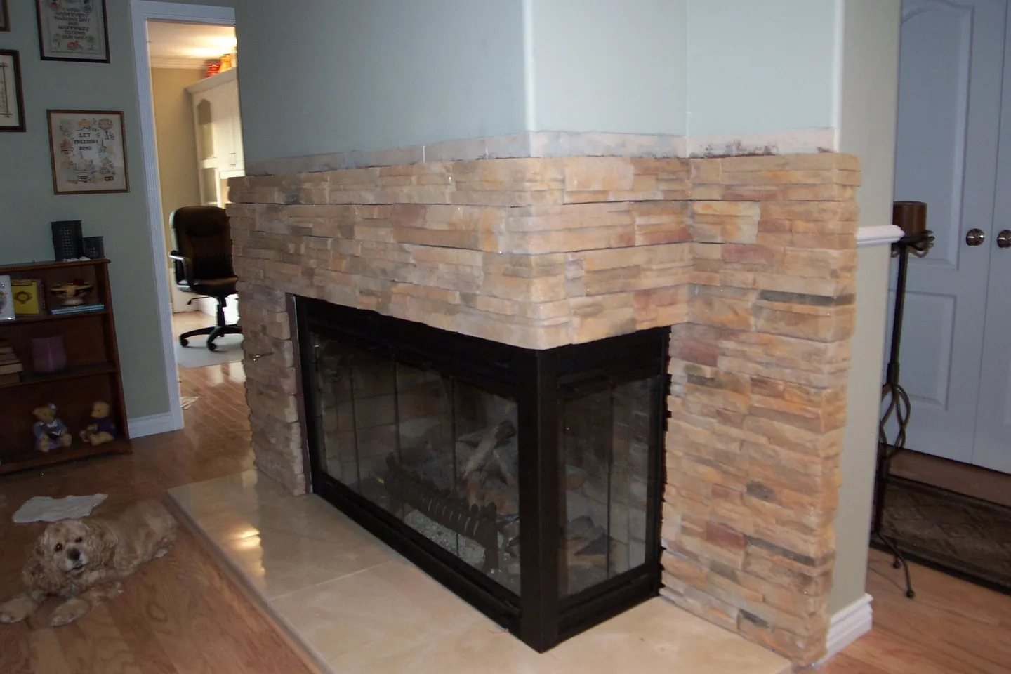 A fireplace with a stone surround and hearth.