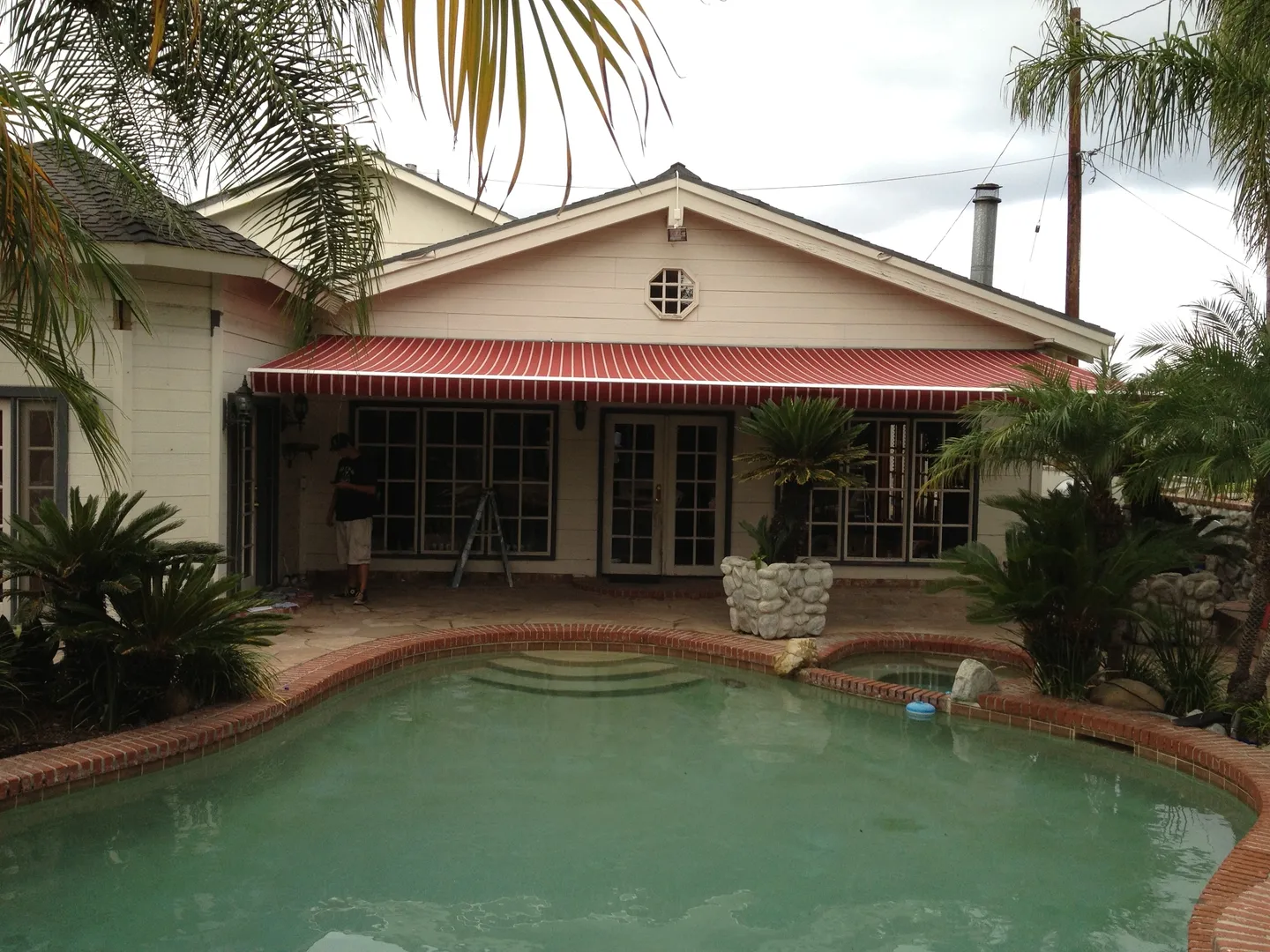 A pool with a red awning over it